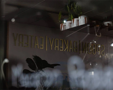 Spoon Bakery and Eatery interior design reflecting off a glass case